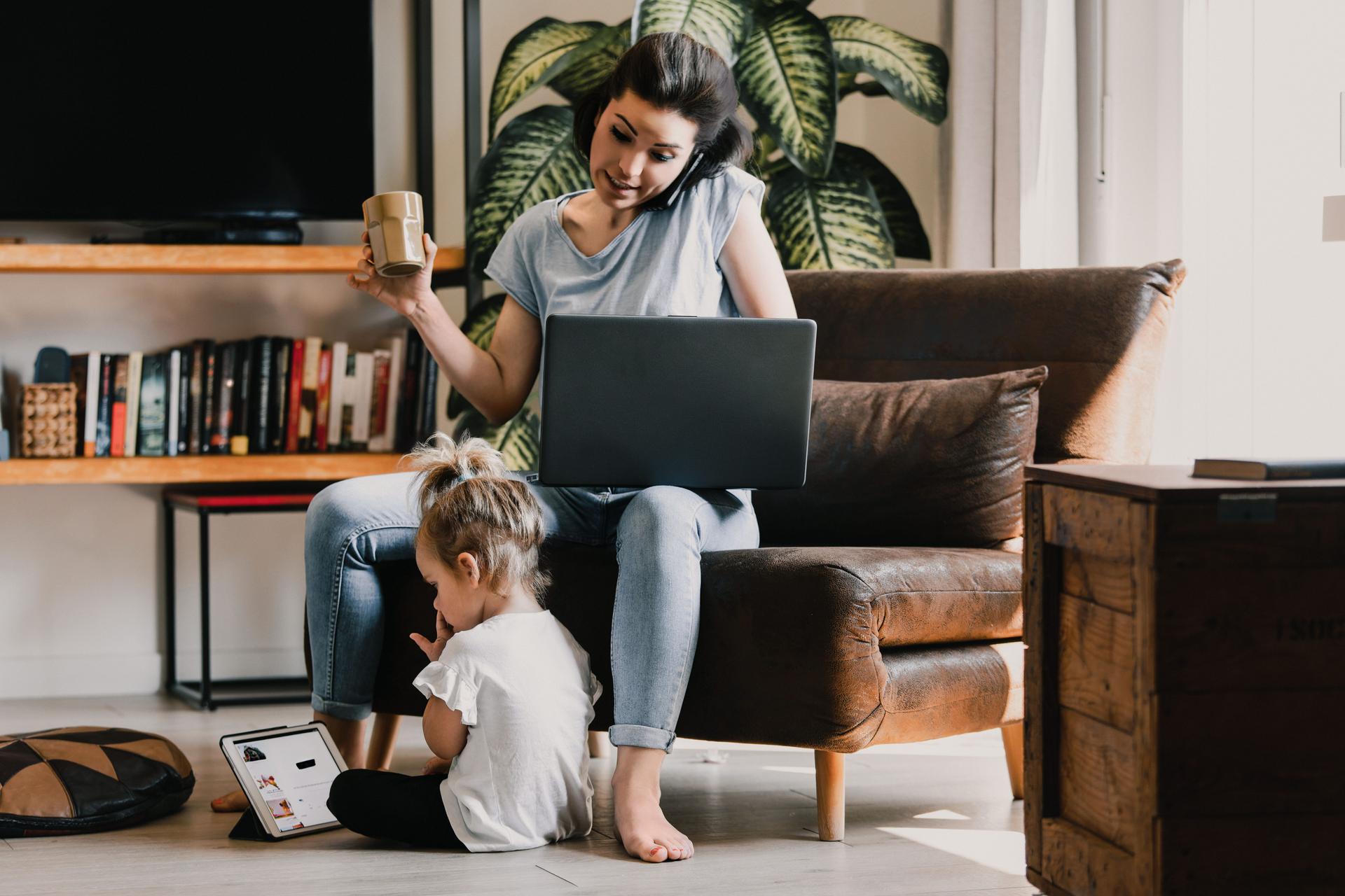 Mother managing work and childcare responsibilities at home