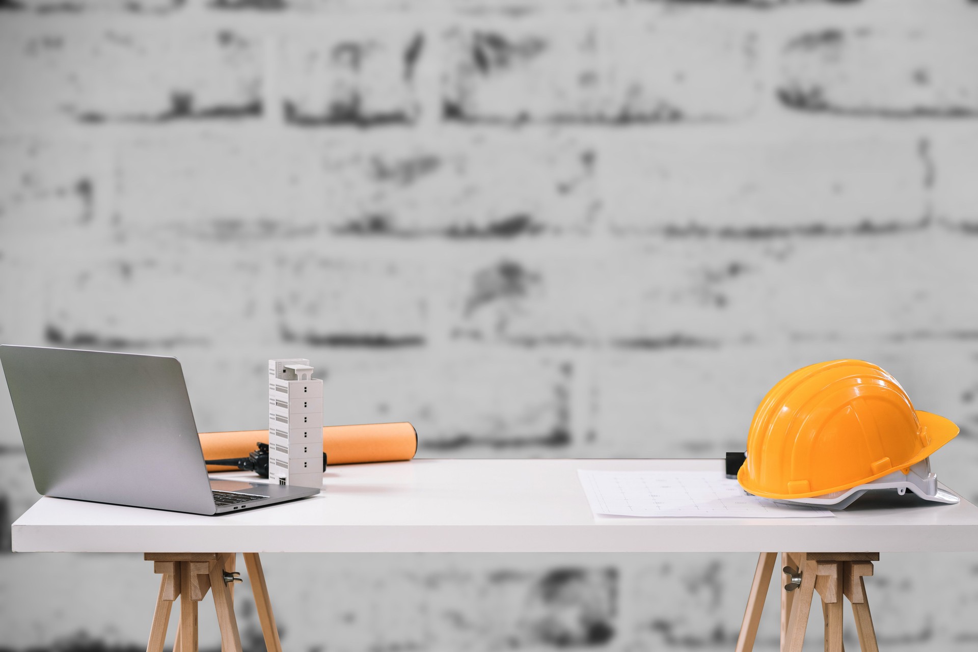 Construction house and building. Repair work. dof laptop computer and office construction on table in office blurred background.Architect concept.
